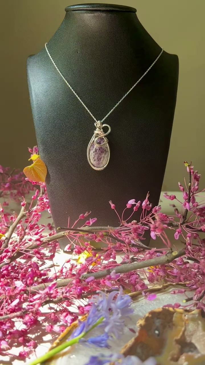 purple crystal on black bust.